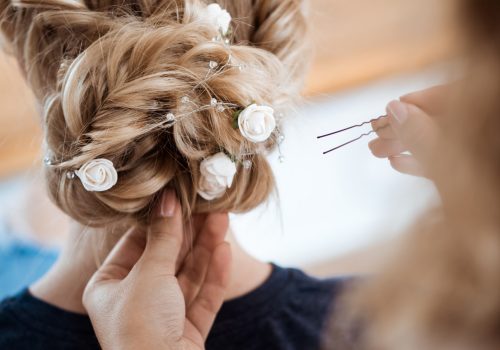 female-hairdresser-making-hairstyle-blonde-woman-beauty-salon-scaled